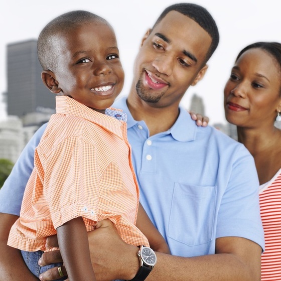 Criança no colo do pai observados pela mãe - ThinkStock Criança no colo do pai observados pela mãe - ThinkStock