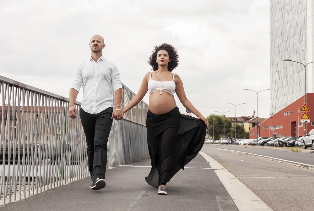 Homem e mulher grávida caminhando juntos de mãos dadas - foto: patronestaff/ShutterStock.com